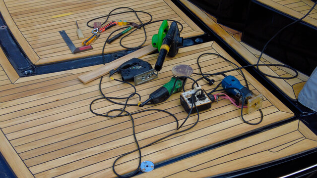 Luxury yacht maintenance. Teak work on the deck, tools on the deck.