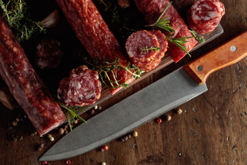 Sliced dry cured sausages with peppercorns, thyme, rosemary, and garlic.