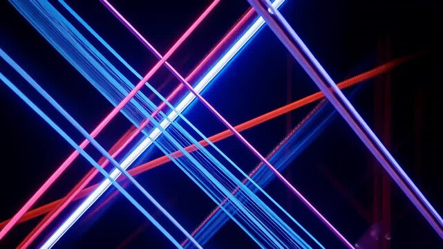 Starting neon light beams sliding, rotating, converging centrally on backdrop, with digital lines