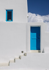 Minimalist Cycladic Architecture: Bright Blue Door and Window on Whitewashed Wall in Santorini, Greece. 7 October 2025