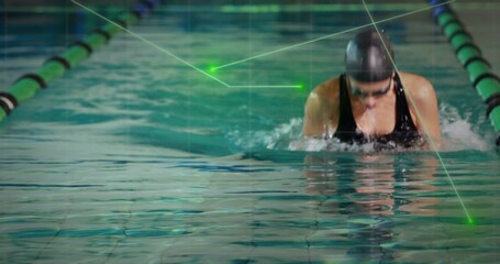 Breaststroking swimmer in lane flanked by green-black dividers wearing black swimsuit, copy space