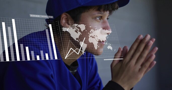 Baseball player in blue cap, jersey sitting in dugout, viewing barchart worldmap linegraph overlays