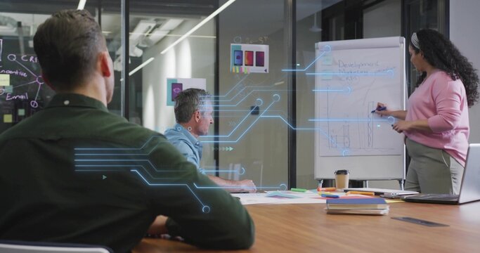 Woman in business casual writing workflow notes on flip chart in modern conference room, copy space