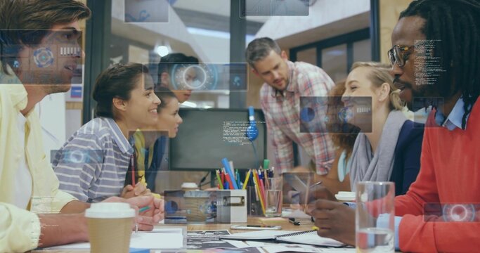 Collaborating team reviewing printed sketches on laptops in conference room, with data overlays