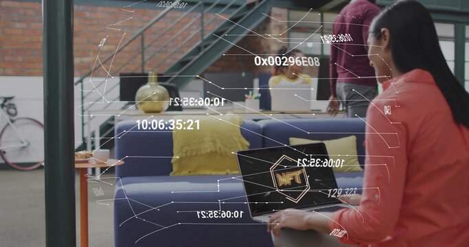 Holding laptop woman in red jacket displaying NFT in startup lounge, with HUD overlays, copy space - Powered by Adobe