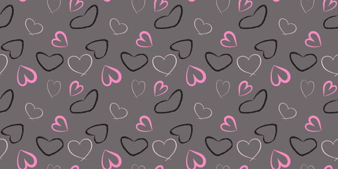 Cute and casual seamless vector pattern of sketchy hand drawn hearts in pink, white, and black on grey background, perfect for romantic gift wrap or Valentine's Day textile print.
