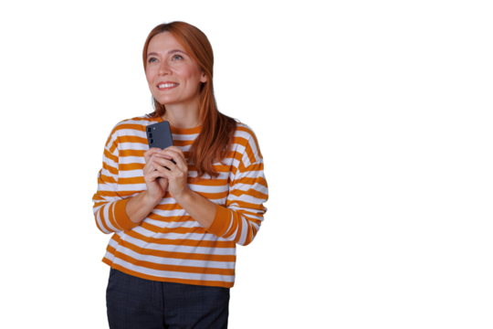 Woman holding smartphone, looking up with hopeful smile, imagining future with technology on transparent background - Powered by Adobe