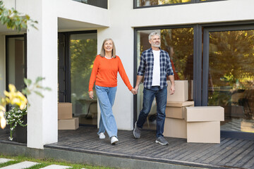 Mature couple walking hand in hand and looking happy