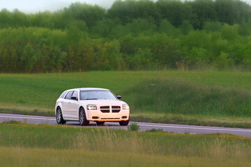 Fototapeta premium Black performance car on empty highway