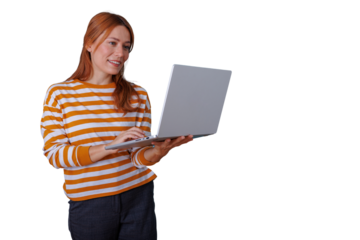 Young woman smiling, holding and typing on a laptop computer, engaged in work or online activities with a transparent background