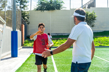 Soccer coach guiding youth player during training session