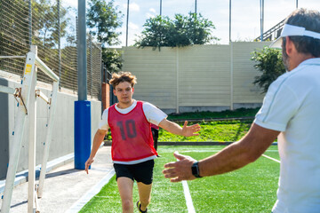 Coach guiding young male soccer player during training