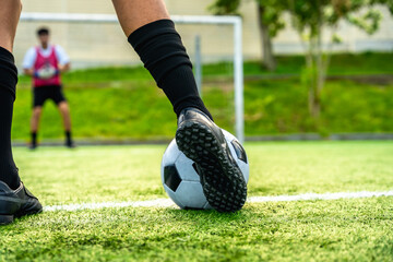 Soccer player kicking ball on penalty spot