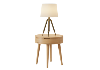 Isolated wood table lamp with shade sitting on a round end table with one drawer