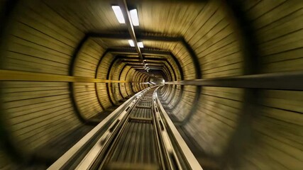 Camera gliding in timber-lined tunnel after ride start, with twin steel rails and rings - Powered by Adobe