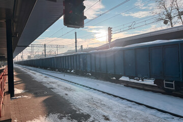 Empty railway platform covered in white snow