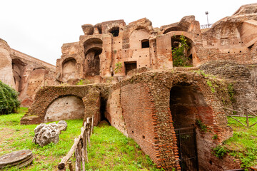 Rome, Italy - 04 November 2012: View of the weathered ruins of the Palatine Hill evoke a sense of ancient grandeur against a backdrop of green vegetation.