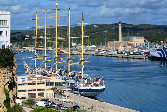 Ma&oacute;, Mah&oacute;n, Menorca, Balearic Islands, Spain, Europe - 10.2025 : Mah&oacute;n Harbour, Royal Clipper - five masted sailing ship, moored at  Maritime Station, CEMEX industrial plant in background
