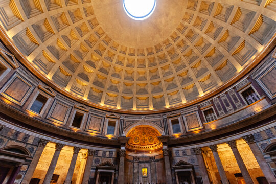 Rome, Italy - 04 November 2012: View of the Pantheon's awe-inspiring dome, its coffers receding into the oculus, bathed in ethereal light, framed by ancient columns and intricate marble patterns.