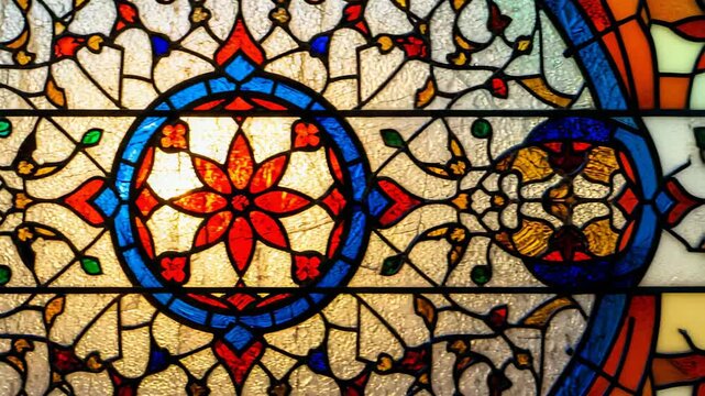 After holding focus on floral motif camera panning, revealing adjacent glass panels in interior