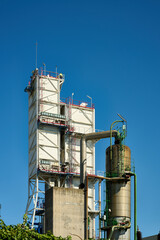 Industrial processing plant structure against blue sky