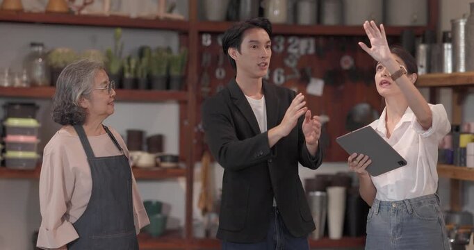 An Asian male investor and team meet with senior female owner at family business ceramic retail shop, negotiating and signing a partnership contract to expand retail and wholesale opportunities.
