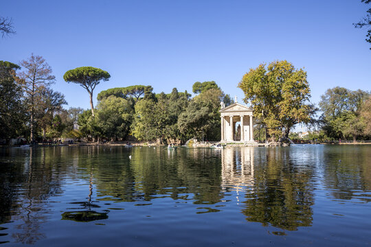 View of the Temple of Asclepius stands serenely on an island in the middle of the lake, its reflection shimmering in the tranquil water, Rome, Lazio, Italy.