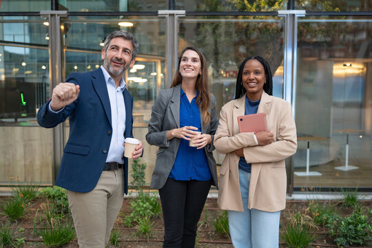 Diverse business team having outdoor coffee break