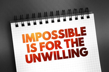 Fototapeta premium Impossible is for the Unwilling text on notepad, concept background