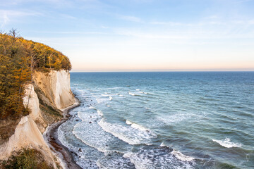 Autumn coast with white cliffs and sea waves. Baltic Sea horizon view.