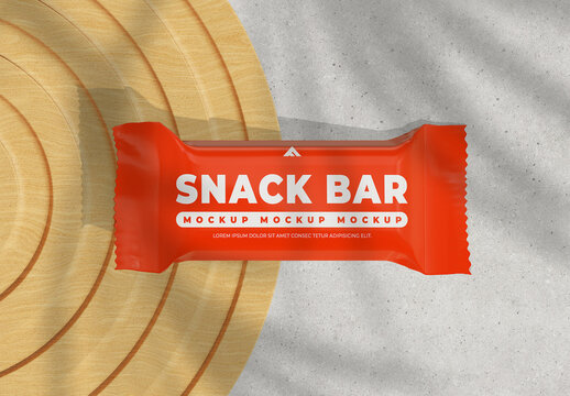 Close-up Snack Bar Wrapper Mockup on a Wooden Surface with Leaf Shadow