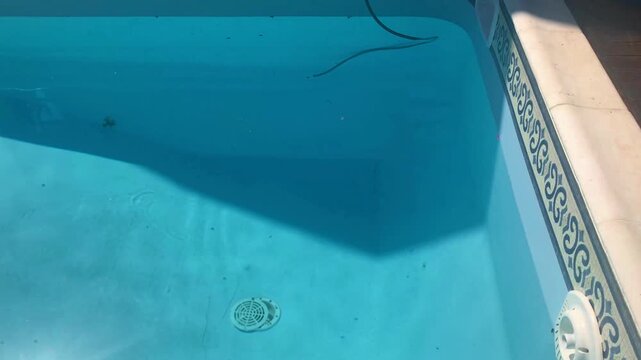 Filling Backyard Swimming Pool with Water Hose