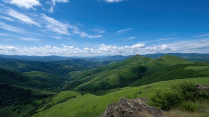 Naklejka premium Sunlit Panoramic Ridge View Overlooking Lush Green Hills and Vast Blue Sky