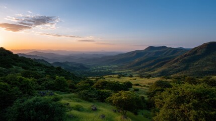 Fototapeta premium Stunning Sunset Over Green Hills in Panoramic View with Soft Colors and Serene Beauty