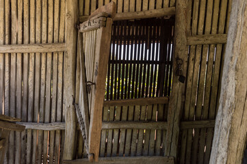 Obraz premium Rural wooden warehouse for storing corn or cereals in the countryside. Wooden storage space for cereals at the farm
