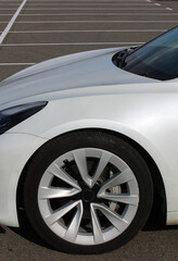 Naklejka premium Vertical stock photo of car on a white lines marking parking spaces on an outdoor parking lot 