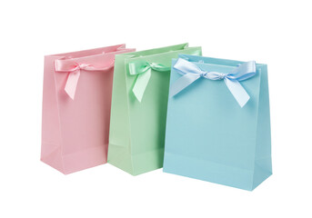Isolated trio of pretty pastel paper shopping bags tied with ribbon bows, no background