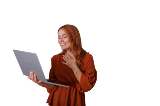 Happy red-haired woman enjoying video call on laptop with hand on chest communicating gratitude, transparent