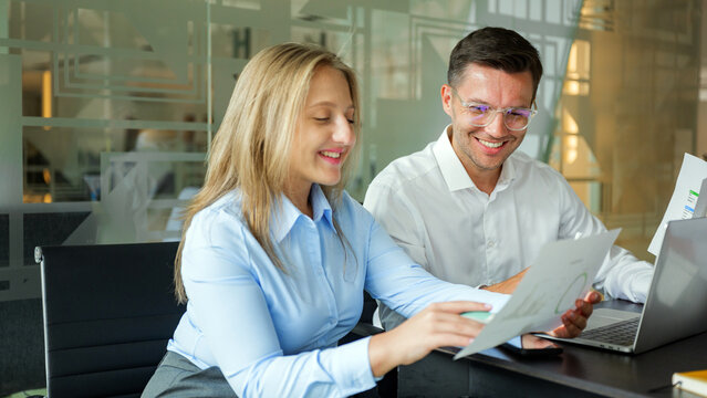Two pros talk documents in an office