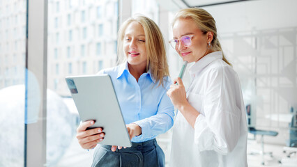 Two women collaborating in modern office setting