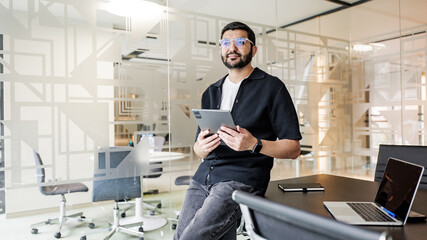 Young man using tablet in modern office space