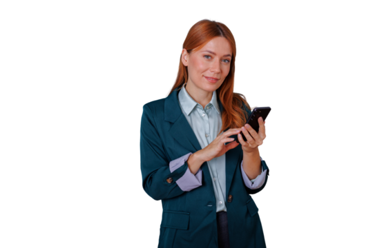 Businesswoman standing, looking camera, holding smartphone, text messaging or browsing, transparent background