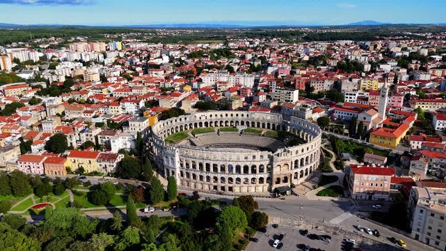 Cinematic Aerial View of Pula, Croatia &ndash; Ancient Roman Amphitheatre, Historic City and Adriatic Coastline from Drone