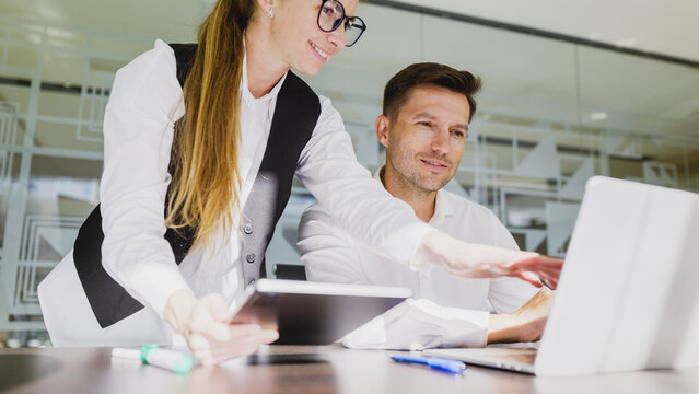 Colleagues collaborating on a project in an office