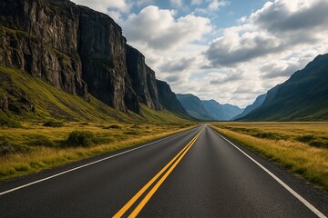 a straight clean road between rock mountain in cloudy weather