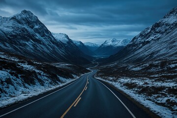 a clean road between snowy mountains in extremw cold weather after heavy snow