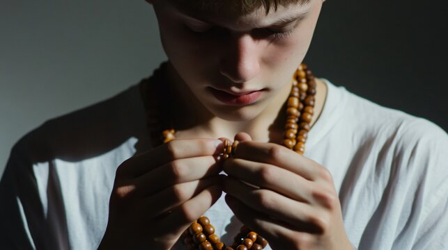 Young man counting wooden beads closely