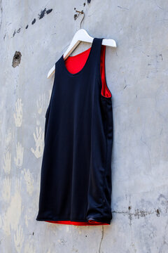 Sleek Black and Vibrant Red Reversible Basketball Jersey Hangs
