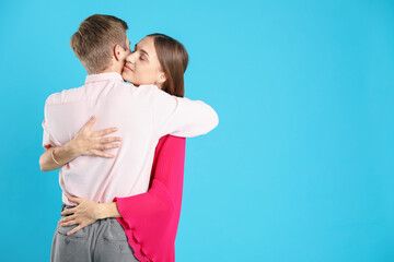 Lovely couple hugging on light blue background, space for text. Romantic date