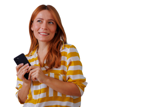 Joyful woman holding smartphone, smiling and looking away, redhead using mobile technology, transparent background